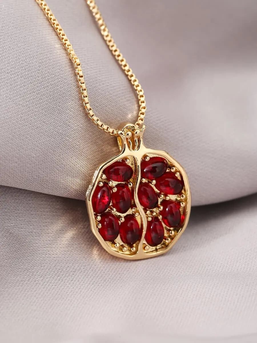 Red pomegranate seed pendant necklace with elegant design and vibrant color